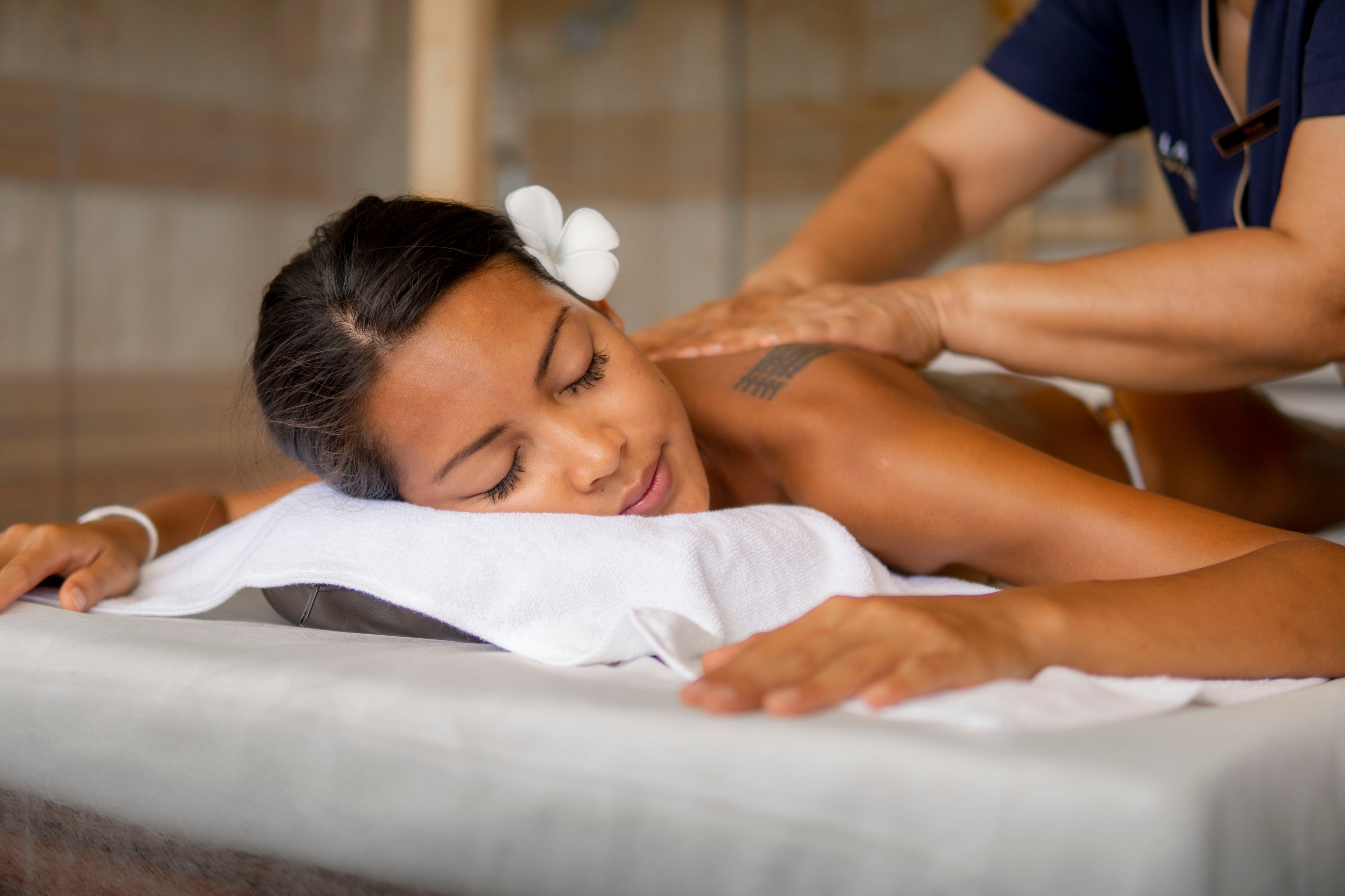 A guest resting with closed eyes during a back massage at Lavella Spa